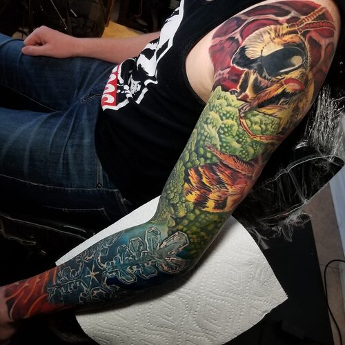 Vibrant color fantasy sleeve tattoo by Mattlock Lopes at Inkcredible Tattoo