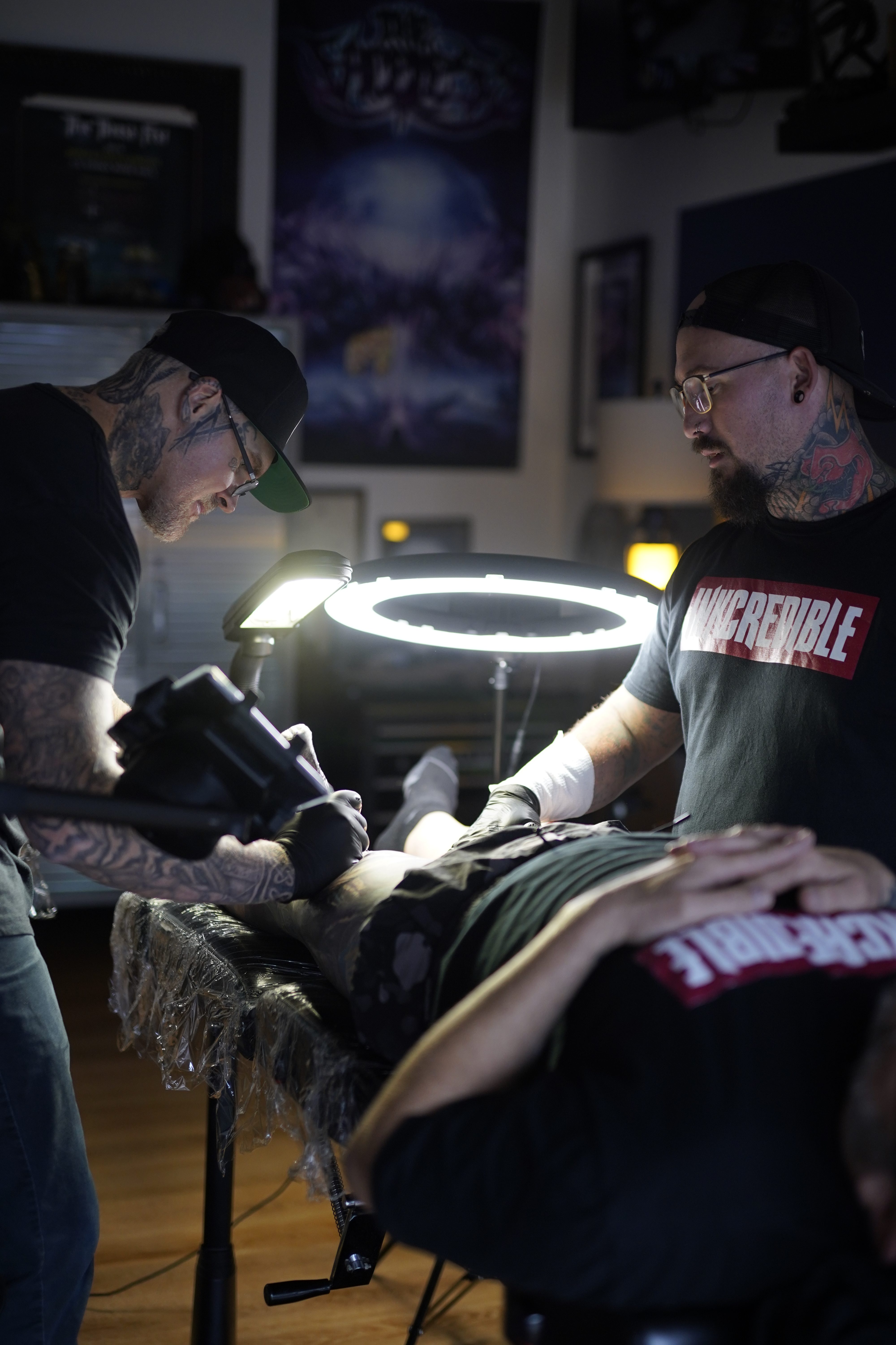 Mattlock Lopes and Burke Long working together on a collaborative tattoo at Inkcredible Tattoo Studio