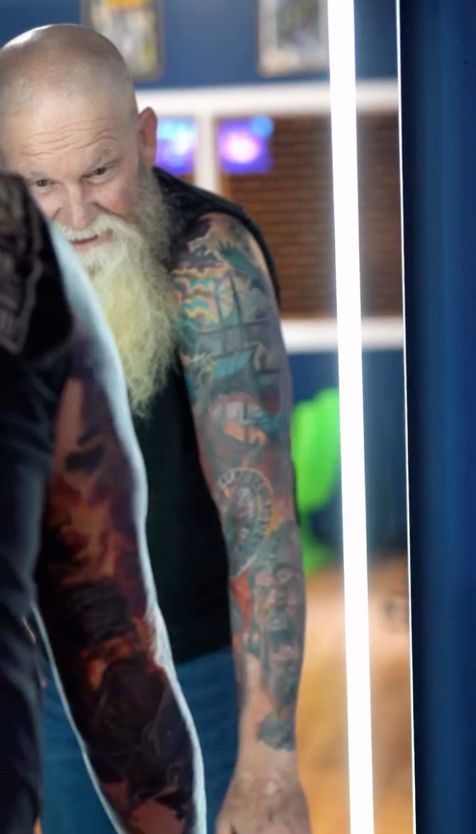 Client reacting to his completed tattoo in the mirror at Inkcredible Tattoo in Virginia Beach